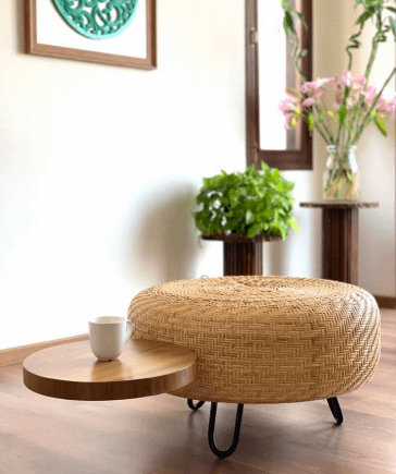 a circular rattan pouffe with a circular attached wooden table