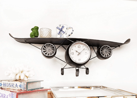 airplane shaped floating shelf placed on the wall