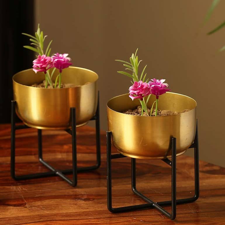 brass planters on a table to enhance decor of the room