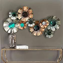 a group of metal flowers placed on wall for wall decor