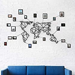 a metal world map with photos installed on wall for decor