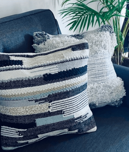 blue textured cushions on a plain sofa