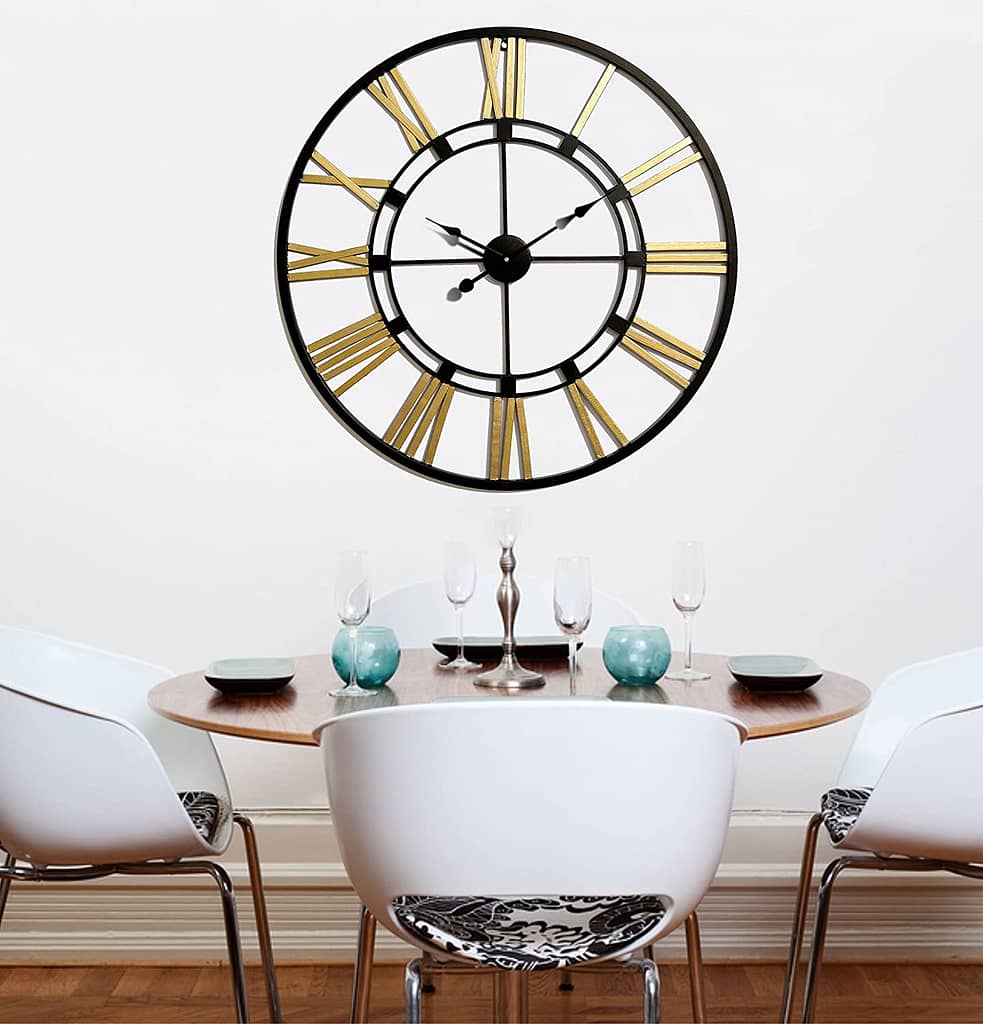 metallic wall clock installed on wall to enhance home decor